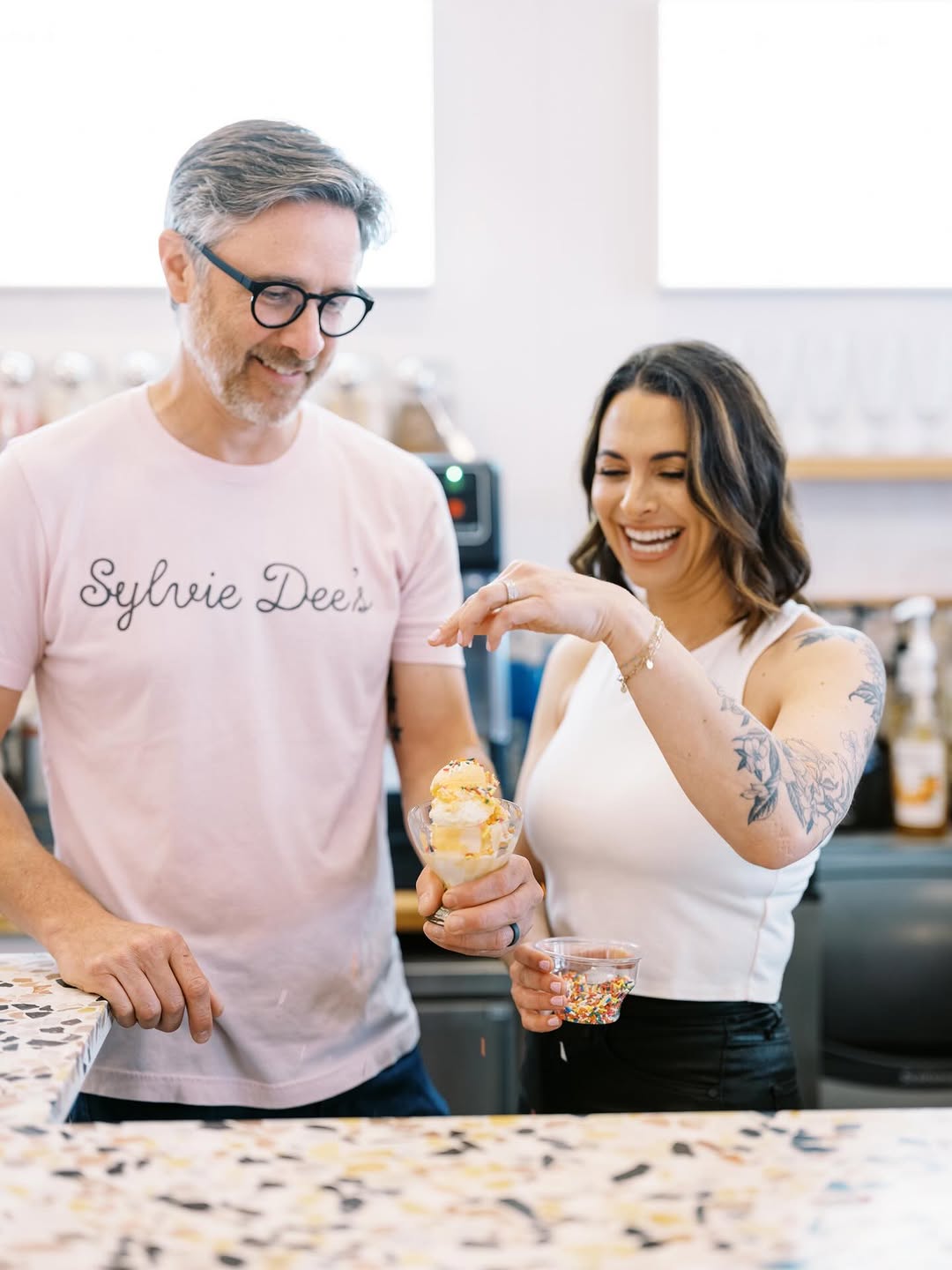 The Sylvie Dee's team adding sprinkles to a sundae